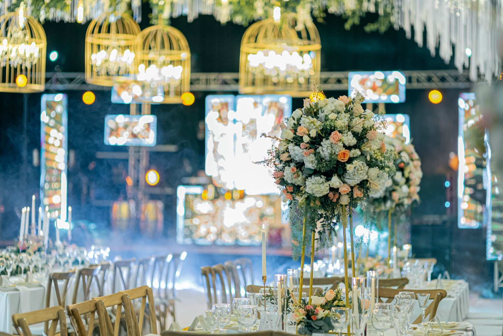 Elegant gala dinner with dressed tables and a lit stage